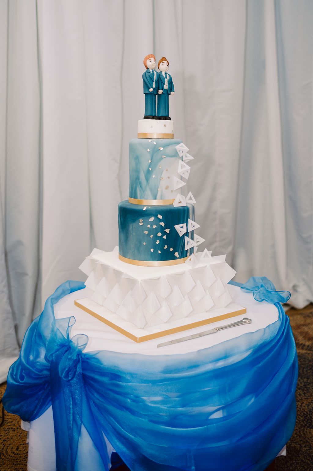 Four tier blue and white wedding cake